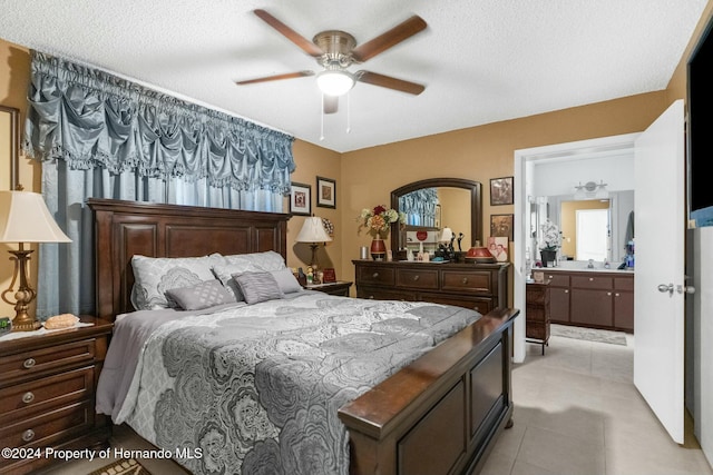 bedroom with light tile patterned flooring, ceiling fan, and a textured ceiling