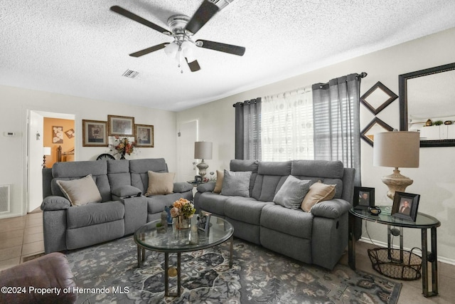 tiled living room featuring a textured ceiling and ceiling fan