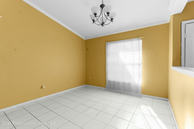 empty room with light tile patterned floors, crown molding, and an inviting chandelier