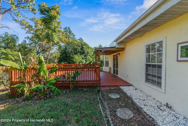 view of yard featuring a wooden deck