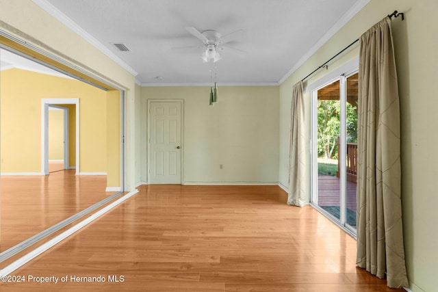 spare room featuring ceiling fan, light wood-type flooring, and crown molding