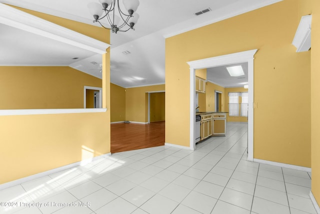 tiled spare room featuring crown molding, lofted ceiling, and a notable chandelier