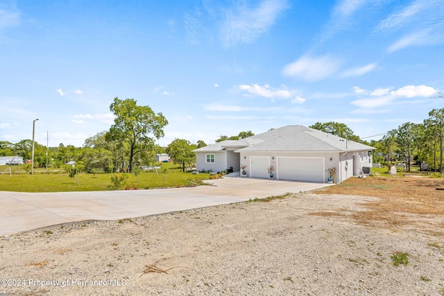 single story home featuring a garage and a front lawn