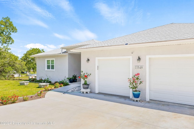 single story home with a front yard and a garage