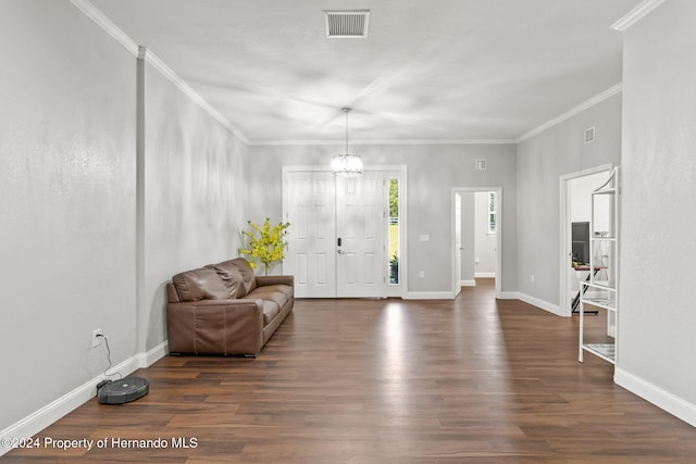 foyer featuring a notable chandelier, crown molding, and dark wood-type flooring