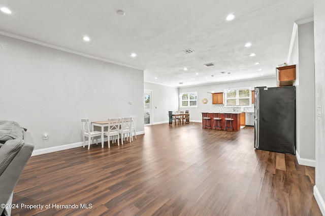 interior space with crown molding and dark hardwood / wood-style flooring