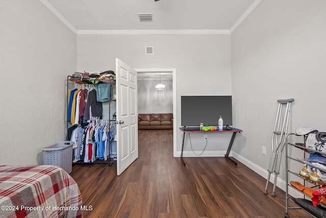 bedroom with dark hardwood / wood-style floors and crown molding