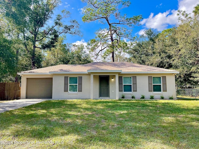 ranch-style home featuring a front lawn and a garage