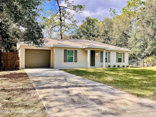 ranch-style house featuring a front lawn and a garage