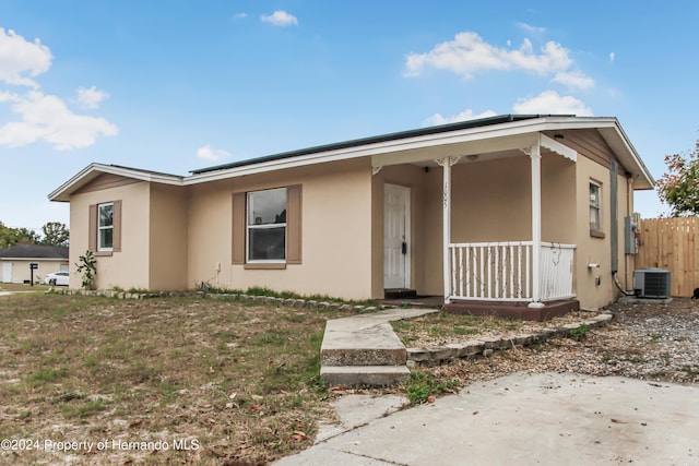 view of front of home with central AC unit and a porch