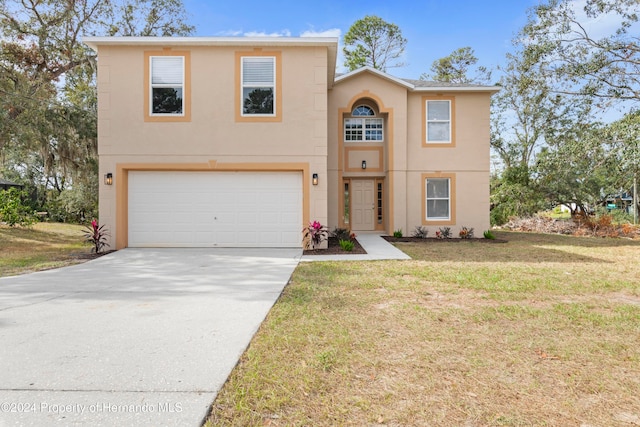 front of property featuring a front yard and a garage