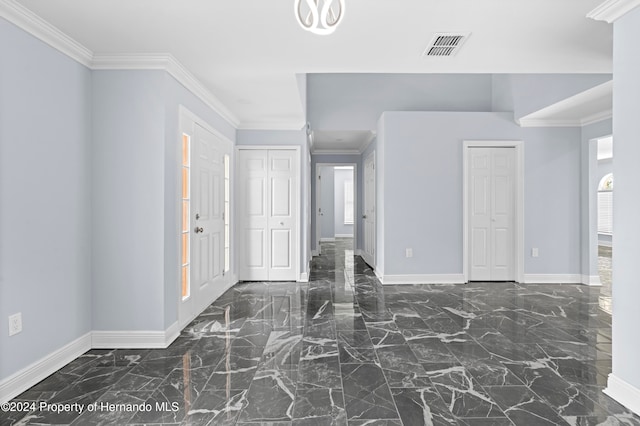 entrance foyer with a wealth of natural light and crown molding