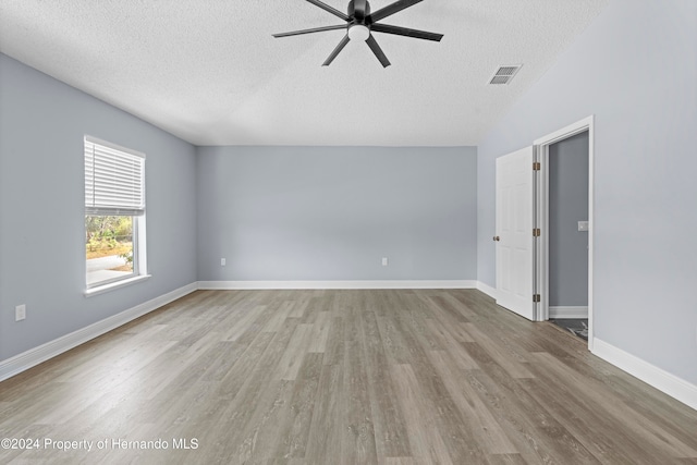 spare room with a textured ceiling, light hardwood / wood-style flooring, and ceiling fan