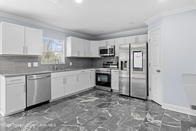 kitchen featuring tasteful backsplash, sink, white cabinets, and stainless steel appliances