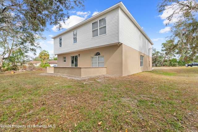 rear view of property with a lawn