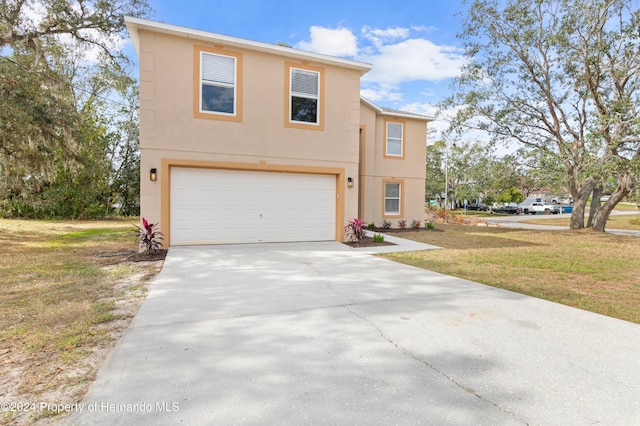 view of front of home with a garage and a front lawn