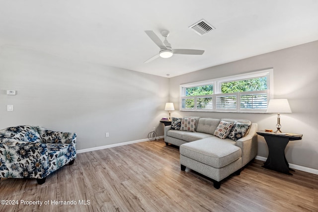 living room with ceiling fan and light wood-type flooring