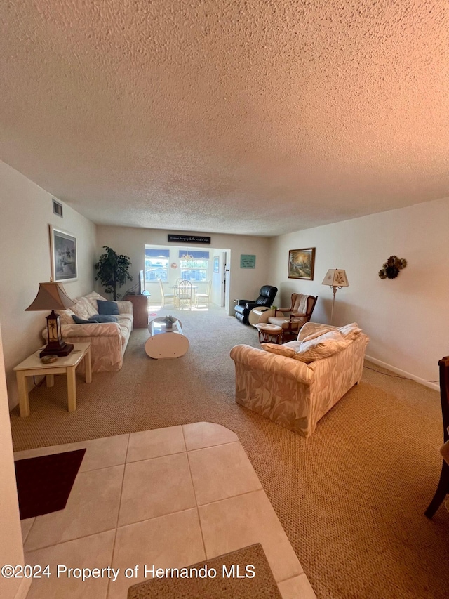 carpeted living room featuring a textured ceiling