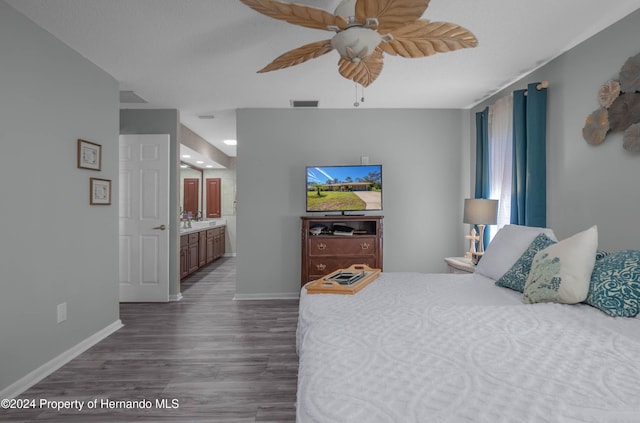 bedroom with ensuite bath, ceiling fan, and dark wood-type flooring