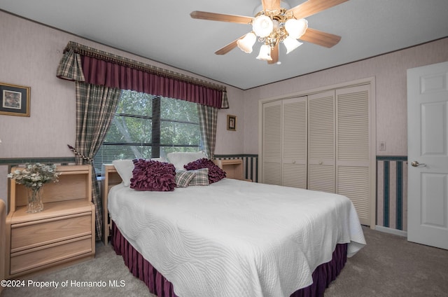 bedroom with carpet floors, a closet, and ceiling fan