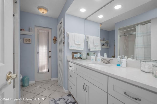 bathroom with tile patterned floors, vanity, and a shower with shower curtain