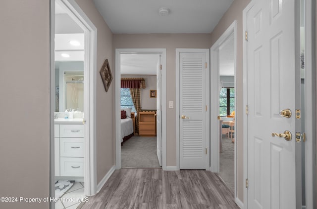 hall with light hardwood / wood-style floors