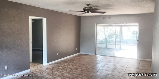 unfurnished room featuring ceiling fan and a textured ceiling