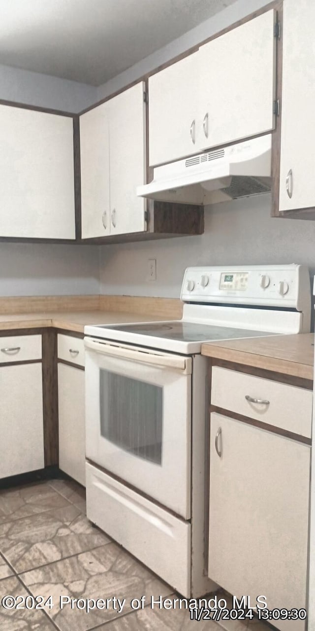 kitchen featuring white cabinets and white range with electric cooktop