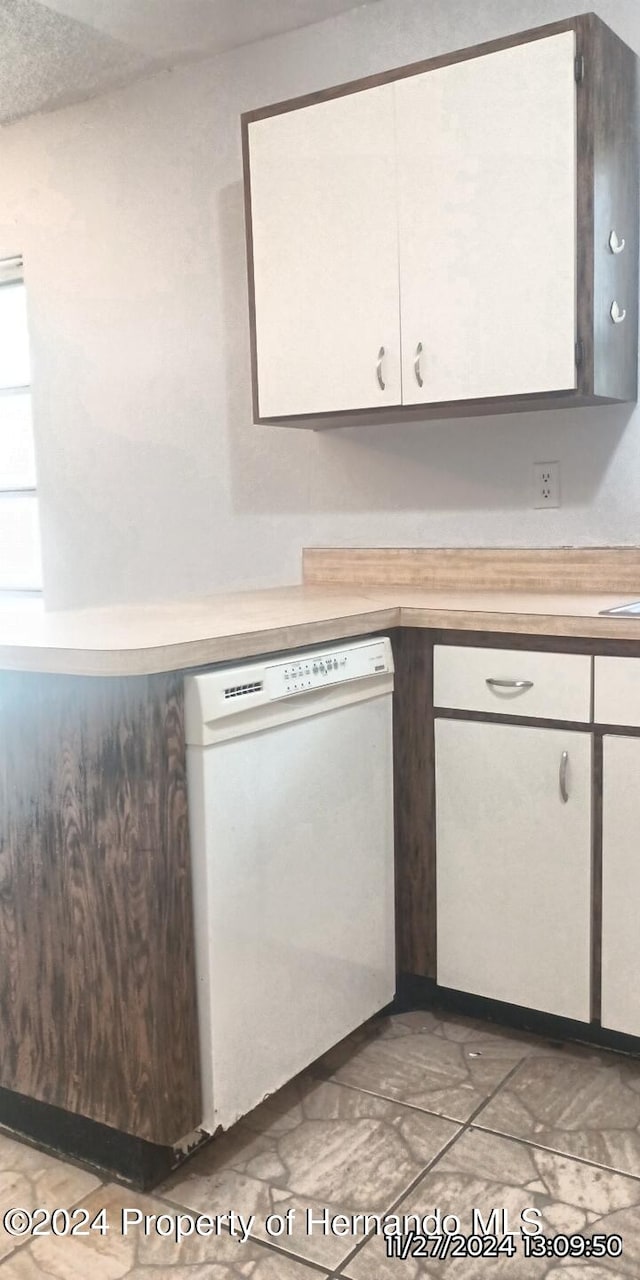 kitchen featuring white cabinets and dishwasher