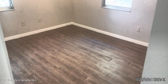 basement with dark hardwood / wood-style floors