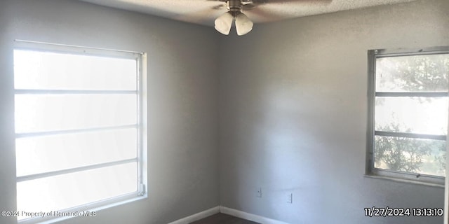 empty room featuring ceiling fan and a healthy amount of sunlight