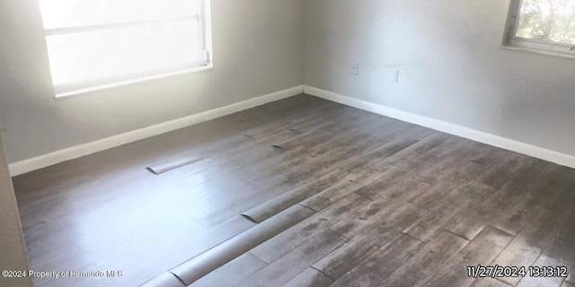 unfurnished room with hardwood / wood-style floors