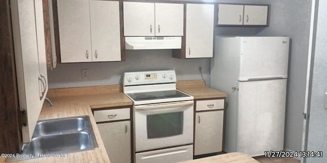 kitchen featuring white cabinets, white appliances, and sink