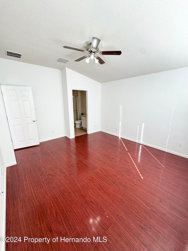 empty room with dark hardwood / wood-style floors, ceiling fan, and a textured ceiling