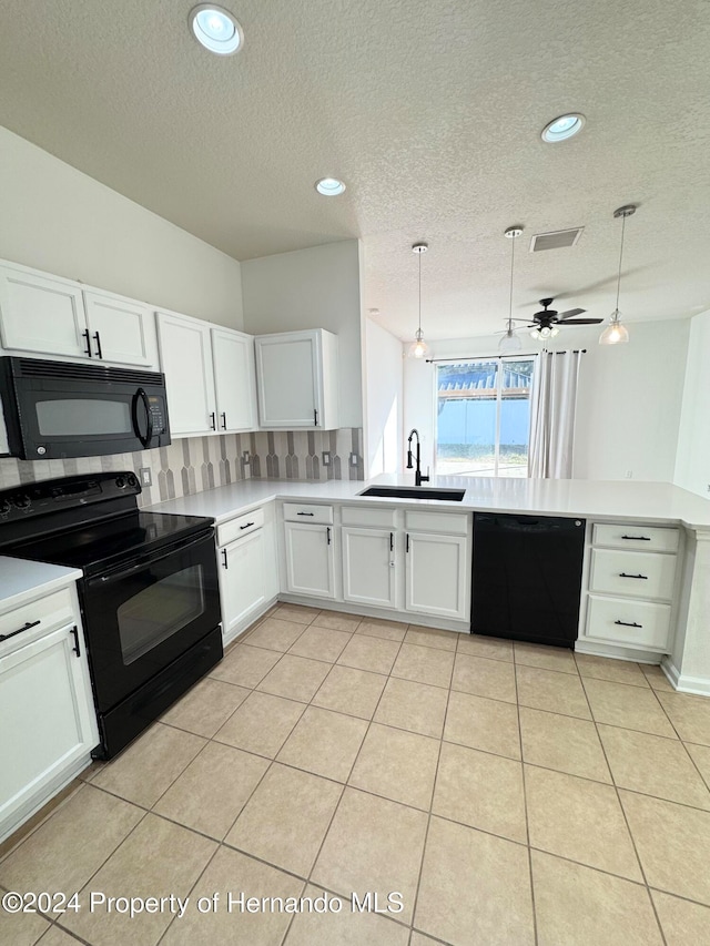 kitchen with black appliances, ceiling fan, white cabinets, and hanging light fixtures