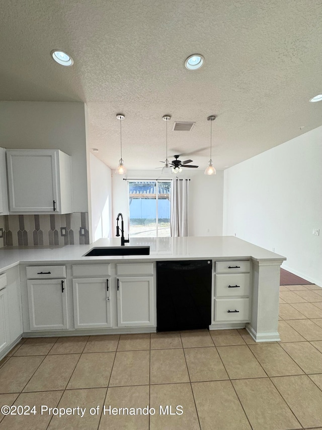 kitchen featuring sink, kitchen peninsula, black dishwasher, decorative light fixtures, and white cabinetry