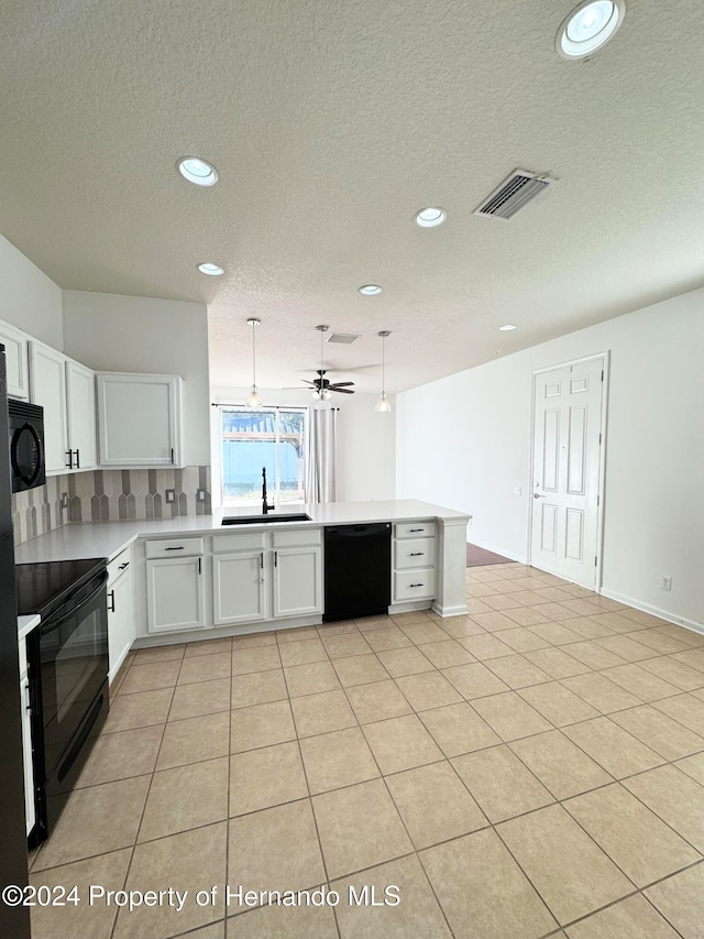 kitchen with kitchen peninsula, ceiling fan, sink, black appliances, and white cabinets