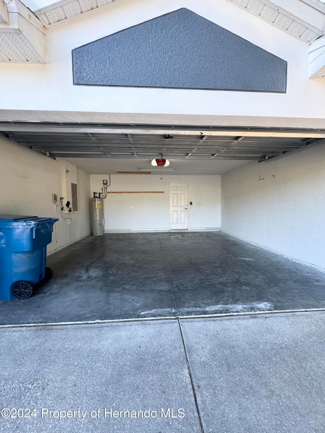 garage with electric panel, water heater, and a garage door opener