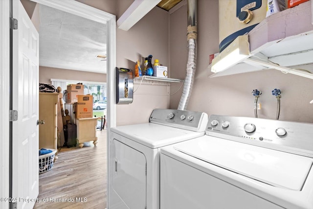 laundry area featuring light wood-type flooring and washer and clothes dryer