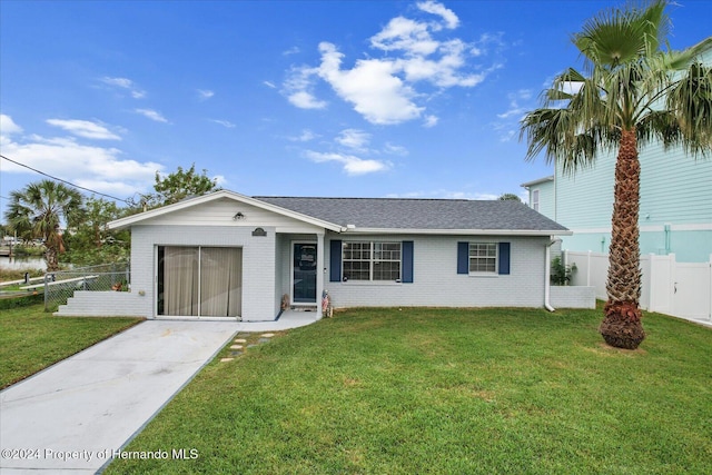 ranch-style home with a front lawn