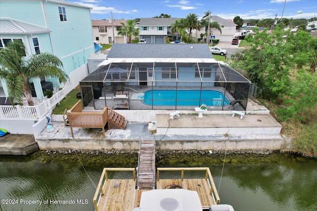 exterior space with a water view, a lanai, and a patio area