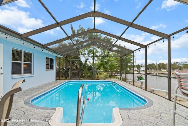 view of pool featuring a patio and glass enclosure