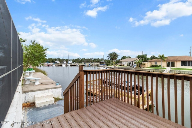 dock area with a lanai and a water view