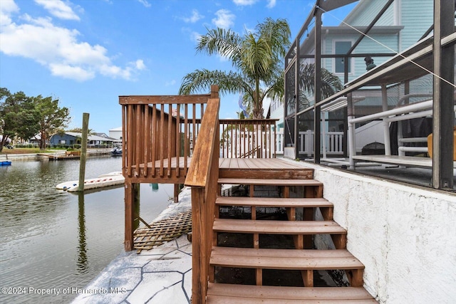 deck featuring a lanai and a water view