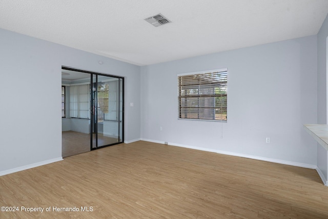 empty room with light hardwood / wood-style flooring