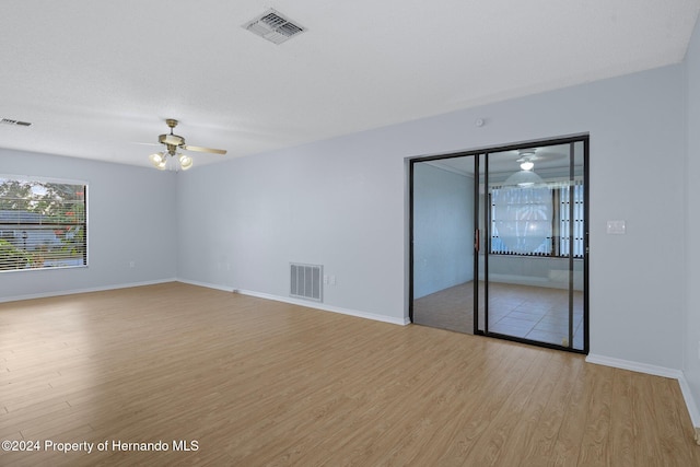 empty room featuring ceiling fan and light hardwood / wood-style floors