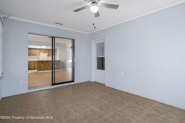 empty room with light tile patterned floors, ceiling fan, and crown molding