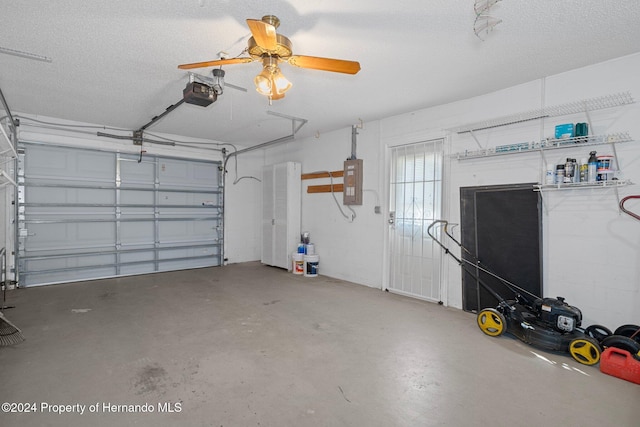 garage with electric panel, a garage door opener, and ceiling fan