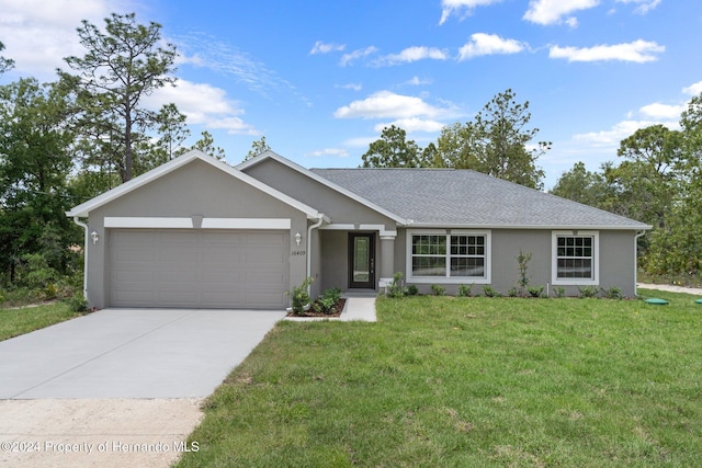 single story home featuring a garage and a front lawn