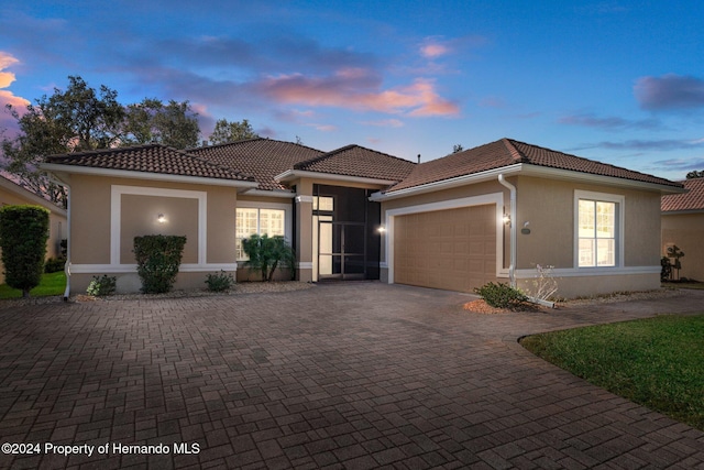 mediterranean / spanish house with a garage